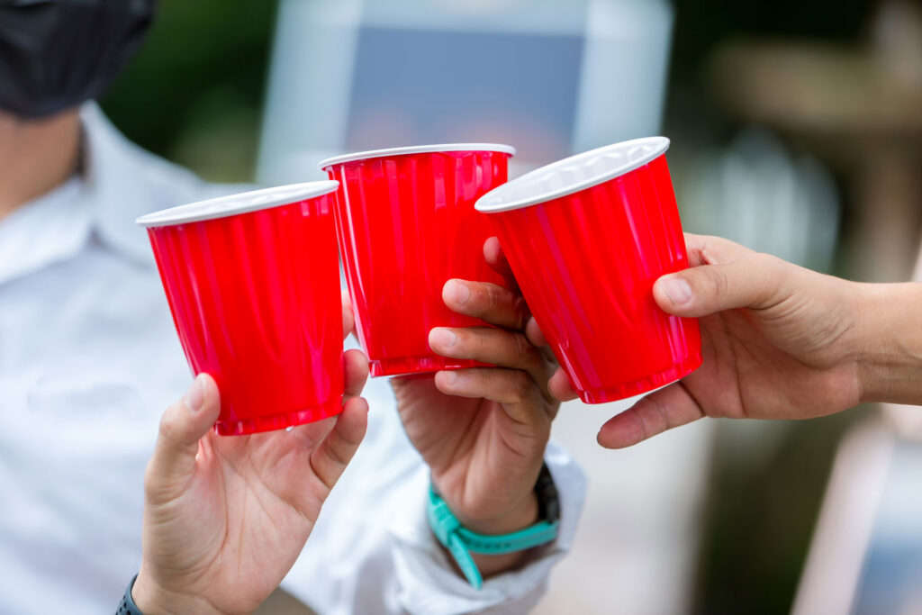 Hands of people mixing alcohol with party drugs